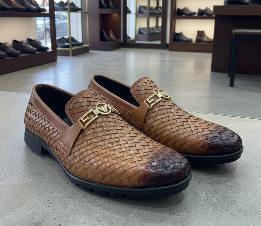 Brown woven shoes with gold accents on a gray floor, with shoe shelves in the background.